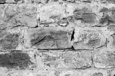 Taşların dokusu ve arkaplanı. Siyah çatlak kaya dokusu arka plan için kullanılabilir.