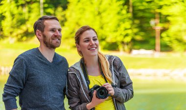 Young couple with a camera in nature on a trip.