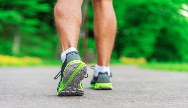 Athletes legs in sneakers on a run close-up