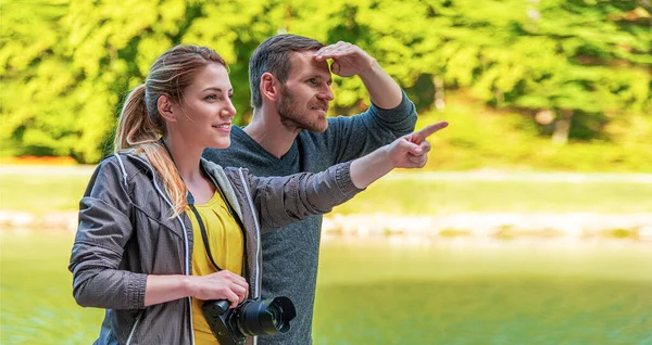 Young couple with a camera in nature on a trip.
