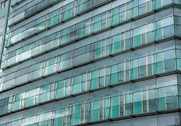 The wall of glass windows of a modern building.