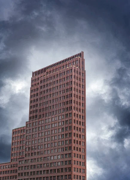 Old building under the dark storm clouds.