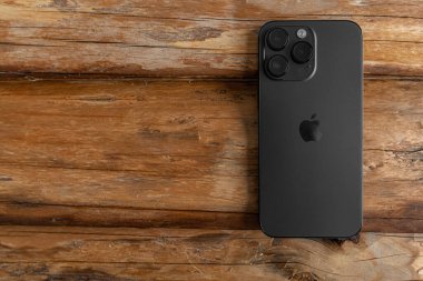 Uzhgorod, Ukrayna - 05 Mayıs 2023: Tahta arka planda Yeni Apple iPhone 14 Pro Max Space Black.