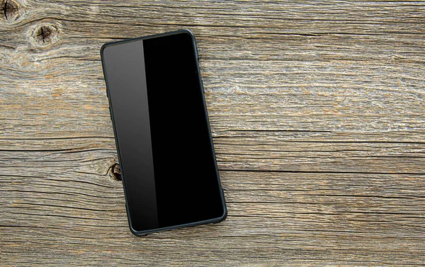 Schwarzes Smartphone Auf Holztisch — Stockfoto
