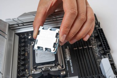 Uzhgorod, Ukrayna - 28 Ağustos 2023: AMD Ryzen 9 7950X3D işlemcinin ana karta elle kurulumu.