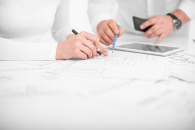 Ofisteki mühendisler proje çizimleri üzerinde görüşüyorlar..