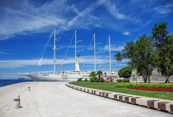 Limanda yelkenleri indirilmiş beyaz yelkenli gemi..