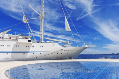 Limanda yelkenleri indirilmiş beyaz yelkenli gemi..