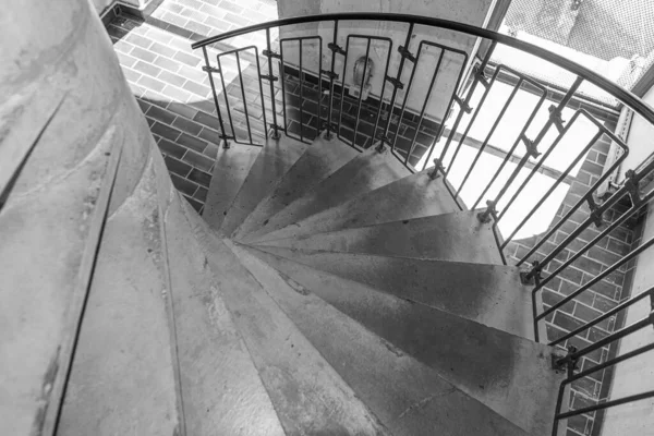 Spiral concrete staircase. Stone steps of a round staircase.