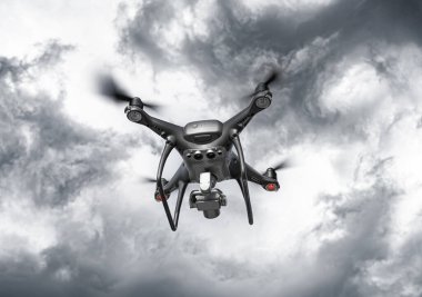 Kameralı modern drone gökyüzünde uçuyor..