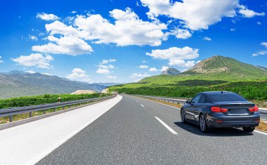 Araba otoban boyunca sürüyor. Etrafı resimlerle çevrili..