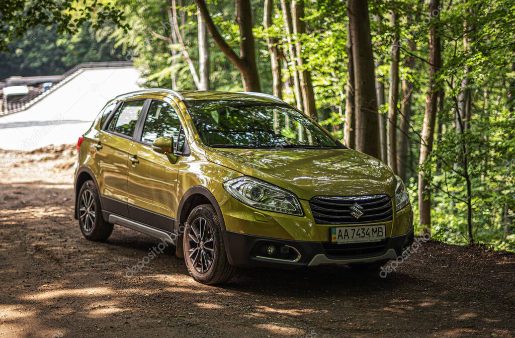 Uzhgorod, Ukraine - June 17, 2019: Suzuki SX4 car parked in the park.