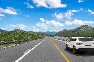 Araba otoban boyunca sürüyor. Etrafı resimlerle çevrili..