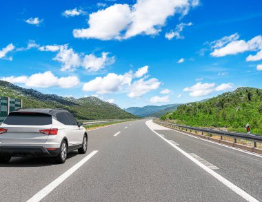 Araba otoban boyunca sürüyor. Etrafı resimlerle çevrili..