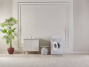 Oda konseptinde çamaşır makinesi giysileri, bitki ve sepet tarzında dolap vazosu, dekoratif açık kahverengi duvar arka plan tarzı.