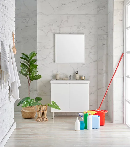 Bathroom interior style with cabinet mirror and white ceramic background, cleaning material, towel, wicker vase of plant, interior decor.