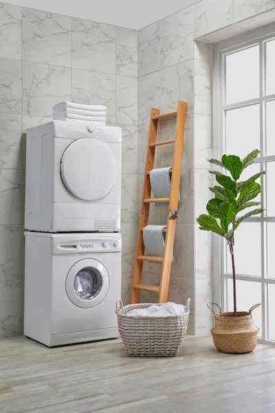 Washing and dryer machine in a row, decorative bath room style, corner concept.
