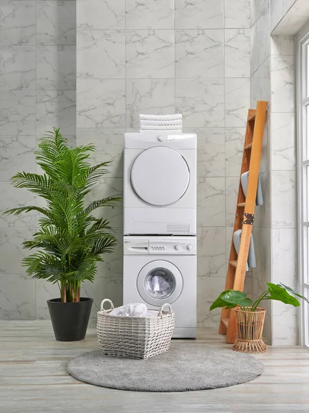Washing and dryer machine in a row, decorative bath room style, corner concept.