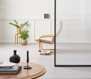 Rocker chair in the white room, brick and classic wall background, chamber, green plant leaf close up blur, working table.