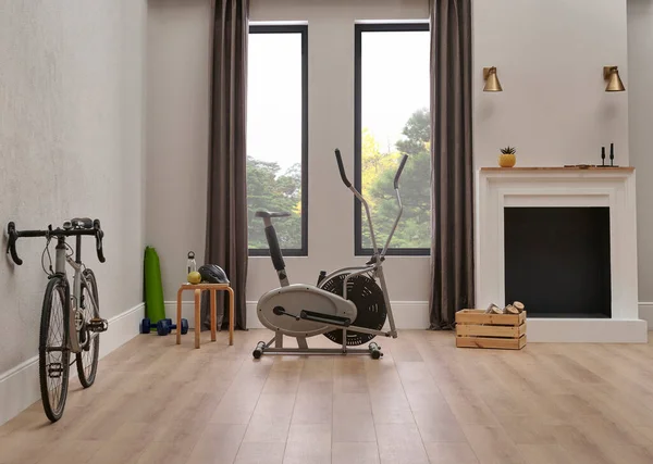 Modern sport room concept with bike and house style, decorative fireplace.