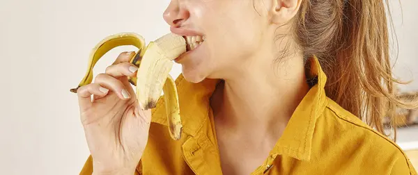Woman Eating Banana Close Hand Mouth Kitchen Background — Stock Photo, Image