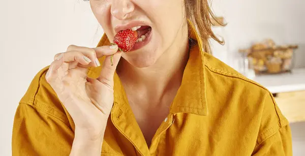 Woman Eating Strawberry Close Hand Mouth Kitchen Background — Stock Photo, Image