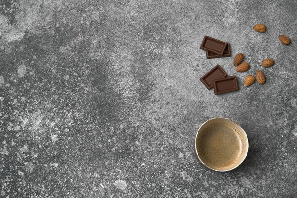 Ceramic glass coffee style, chocolate and almond on the stone table background, grey decorative styling.