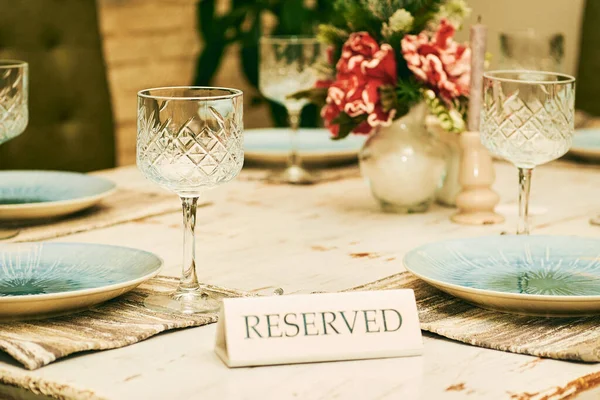Reserved table in a cafe restaurant with wine glasses and plates