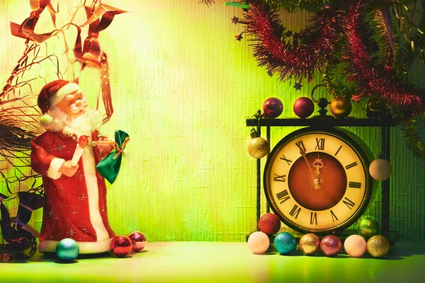 the annual Christian festival celebrating Christs birth, held on December 25 in the Western Church. Santa Claus and vintage clock. New Years Christmas toys,garlands