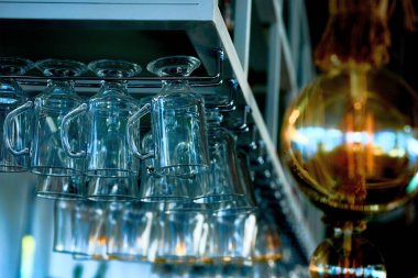 A set of wine glasses on the bar before serving and an electric lamp                               