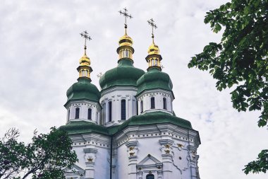 Golden domes with dark green roof of the Vydubychi Orthodox Monastery in Kiev