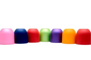 Multicolored bright cones cylinders caps and place for text on white                               