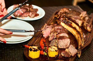 Ready tasty rib meat grilled on a cutting board before serving                               