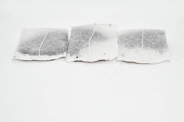 Three useful tea bags for brewing and drinking isolated on white                             