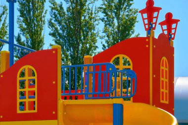 Summer spring children's playground with painted toy ship in park                               