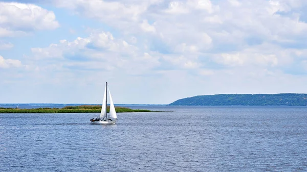 stock image Sailing boat yacht on the river blue expanse on a sunny day                               