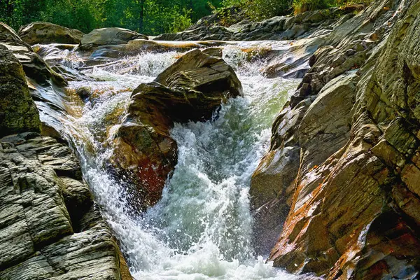 Waterfall, mountain river among the stone rocks