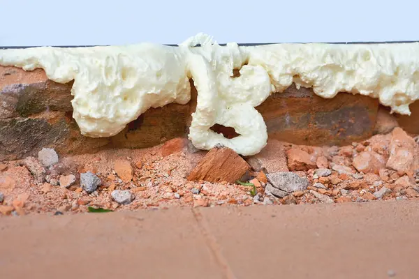 stock image Construction foam. Installation of a metal plastic window,door,brick wall.                                