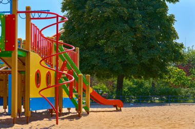 Summer spring children's playground with painted toy ship in park