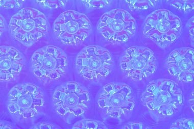 Blue purple abstract wall made from the bottoms of plastic bottles clipart