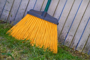 Sarı plastik paspas çöpleri süpürüyor.