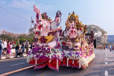 CHIANG MAI, THAILAND - FEBRUARY 04 , 2023  : A car decorated with fresh flowers in the parade of the 46th Chiang Mai Flower Festival moving through Nawarat Bridge Chiang Mai,Thailand.
