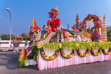CHIANG MAI, THAILAND - FEBRUARY 04 , 2023  : A car decorated with fresh flowers in the parade of the 46th Chiang Mai Flower Festival moving through Nawarat Bridge Chiang Mai,Thailand.