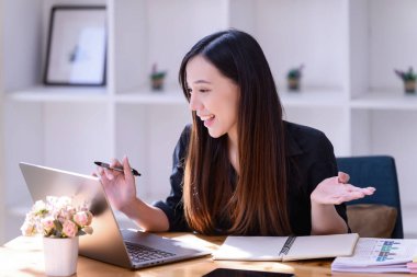İnternette çalışan iş kadınları ofiste dizüstü bilgisayarın önünde buluşuyorlar. Ticaretin gelişigüzel ve başarılı kavramı