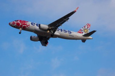 Commercial aircraft overflying the sky and arriving at airport