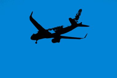 Commercial aircraft overflying the sky and arriving at airport