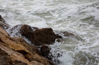 Sonbaharın başlarında Akdeniz kıyısında köpüklü ve çok kötü denizli büyük dalgalar.