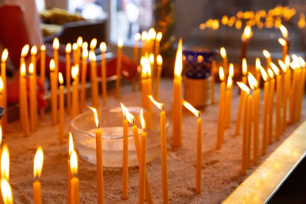 Candles at the entrance of a church to aid prayer and spirituality