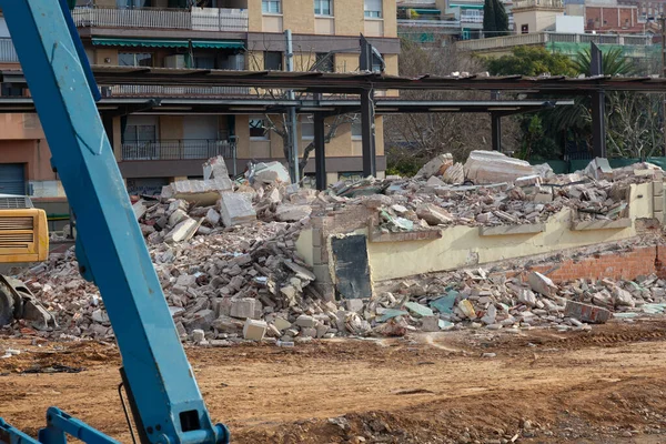 demolition of a building with machines and debris from the building itself, preparation with machines for the construction of a new building or public place