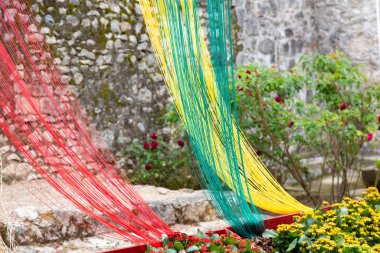 Açık havada metal bir çite asılı saman ve kumaştan yapılmış turuncu cadılar bayramı süslemesi.